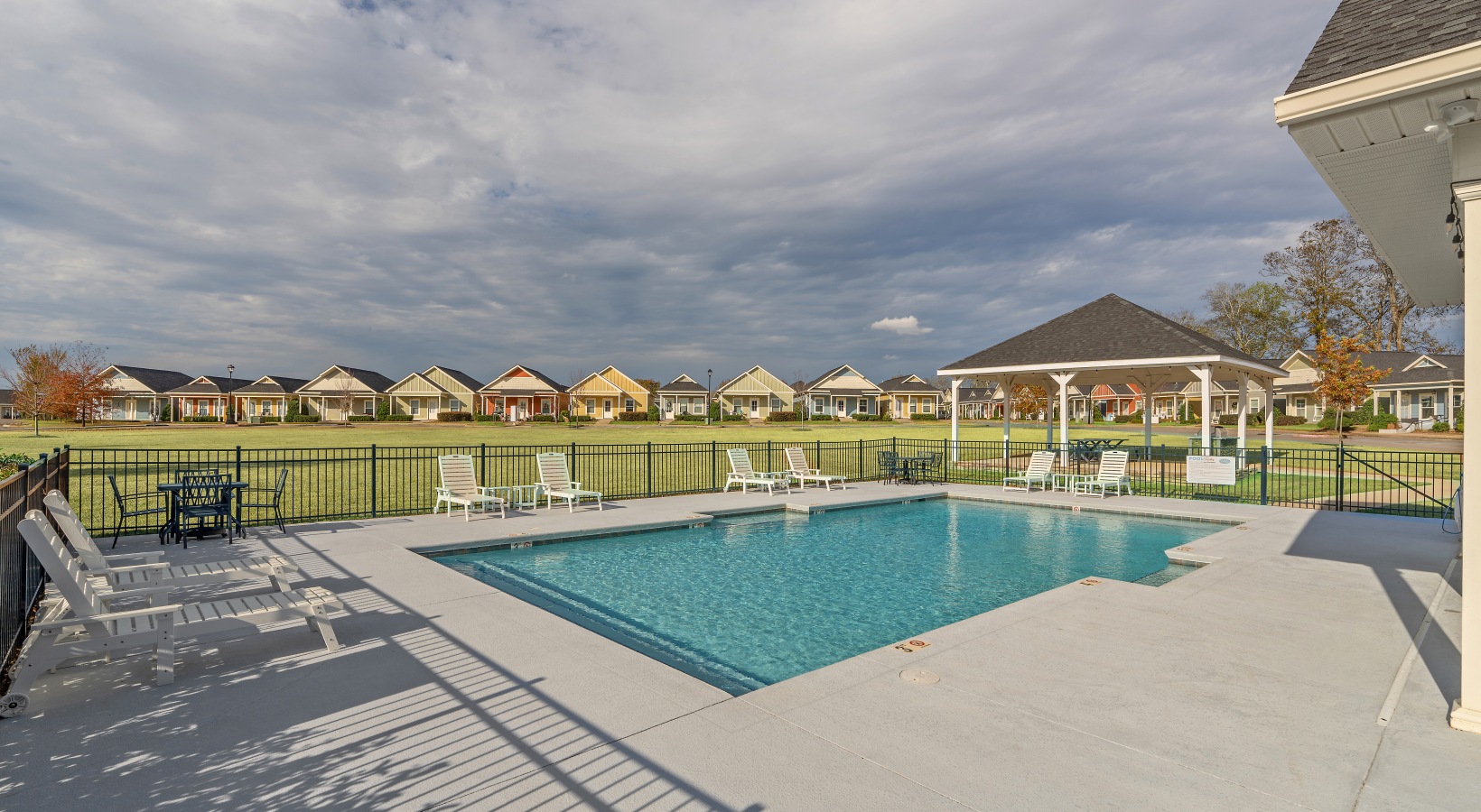 Resort-style pool with seating at Cottages Dothan in Dothan, AL