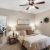 ceiling fan and light fixture in carpeted bedroom